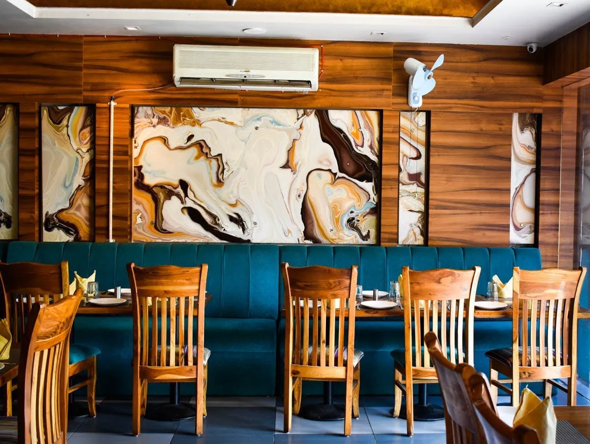 Restaurant interior in Gurugram with ambient lighting and custom seating