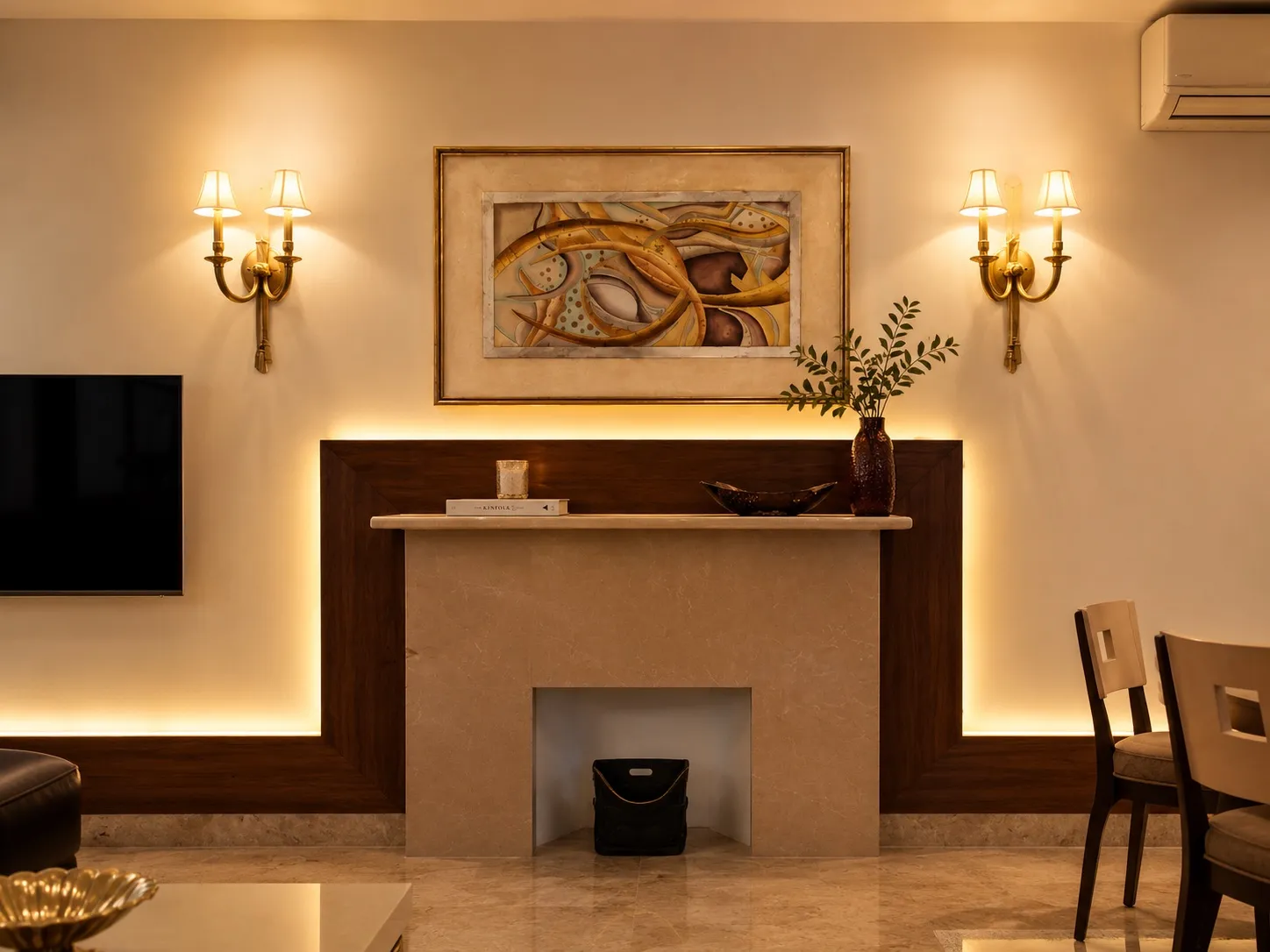 Living area with a beige marble mantel wall in a walnut frame, backlit cove lighting, and a framed abstract artwork