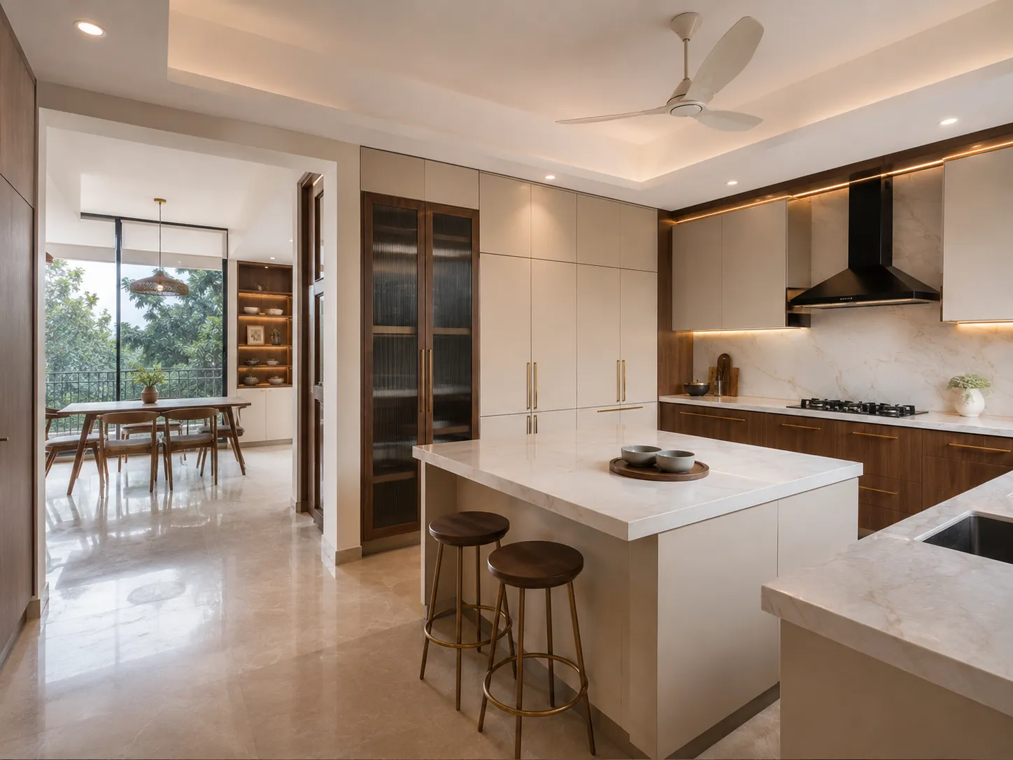 Luxury modular kitchen by Eagle Decor featuring a marble island with two wooden bar stools, beige upper cabinets, wood-finish lower cabinets, and a fluted glass tall unit.
