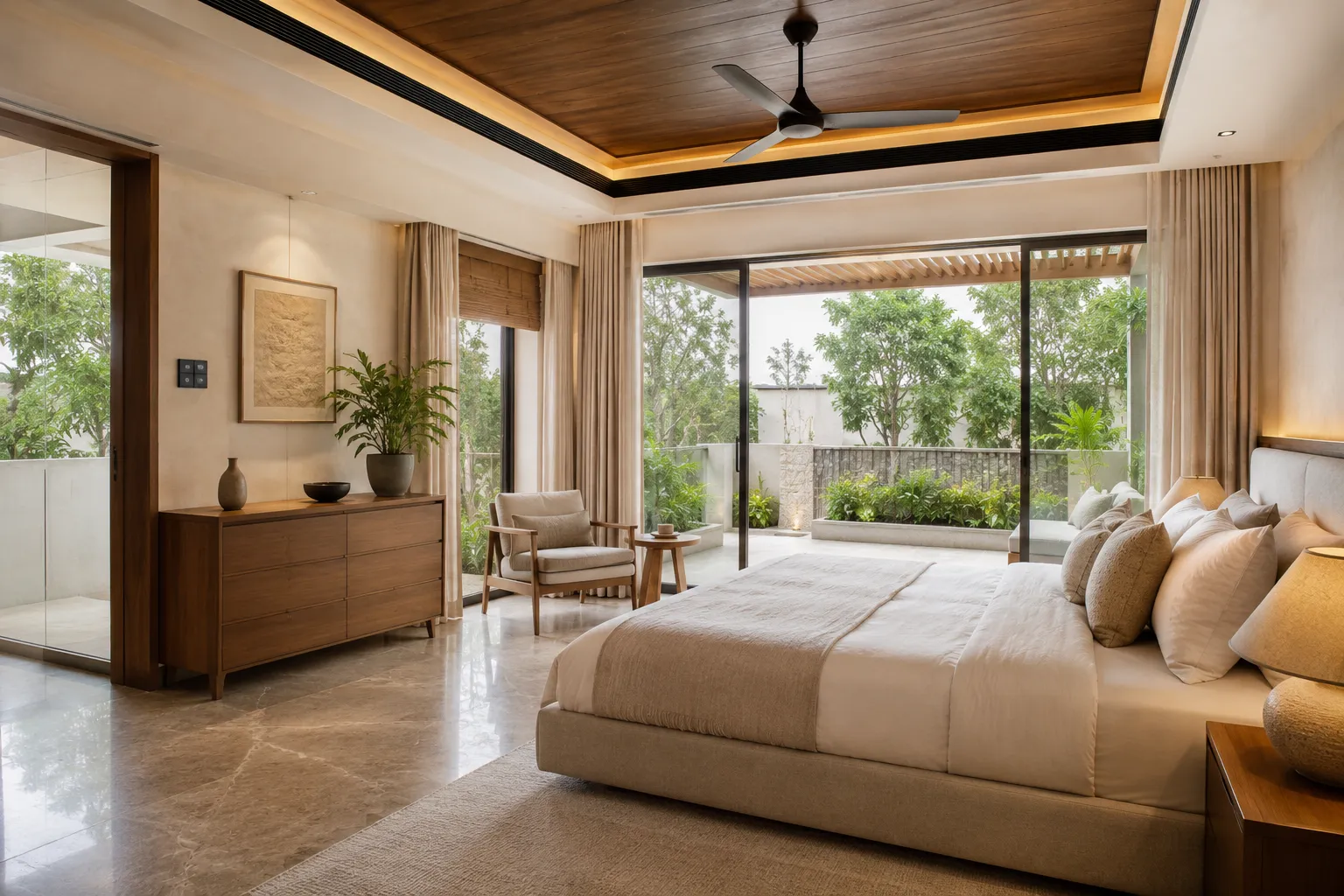 A bedroom with a wooden tray ceiling, marble floors, and a neutral upholstered bed. Large sliding glass doors open to a private terrace filled with green plants.