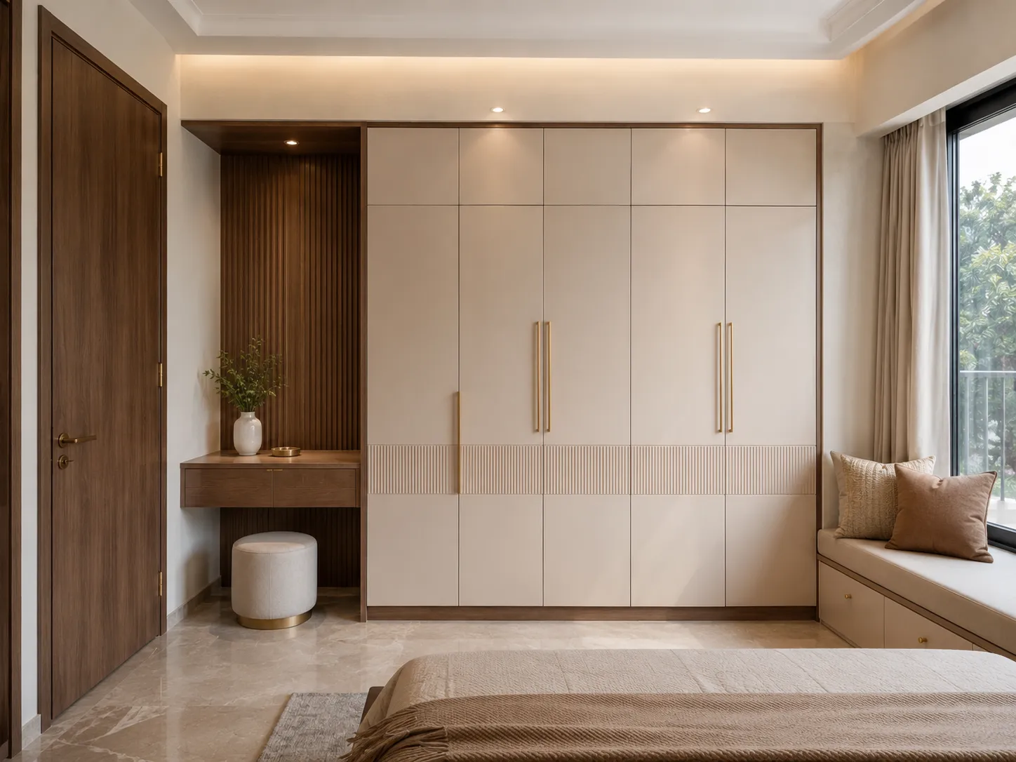 Beige bedroom wardrobe with a textured fluted mid-section, long gold handles, and an adjacent dark wood floating vanity.