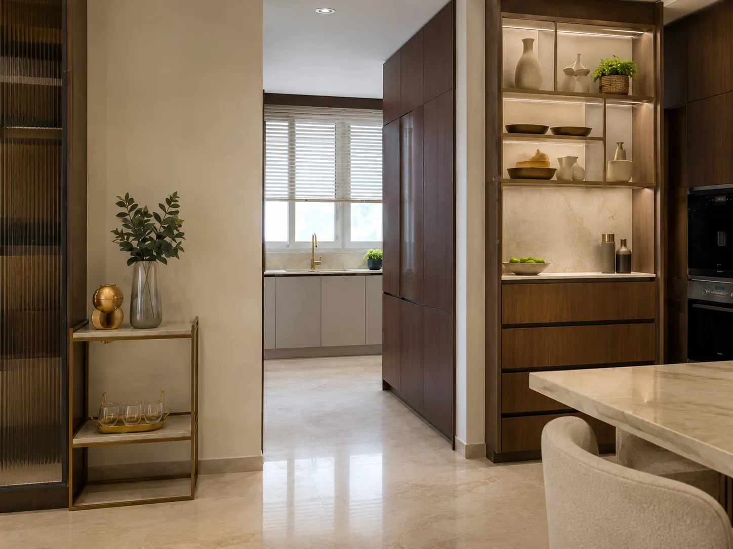 Transition space in a luxury kitchen showing open wooden shelving with ceramics and a clear view into a secondary wet kitchen with light grey cabinets.