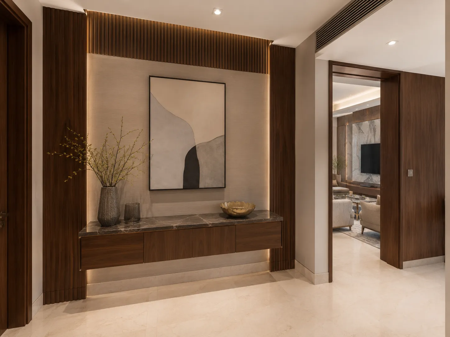Entryway featuring a floating wooden console with a dark marble top, flanked by fluted wood panels with vertical cove lighting and a large abstract painting.